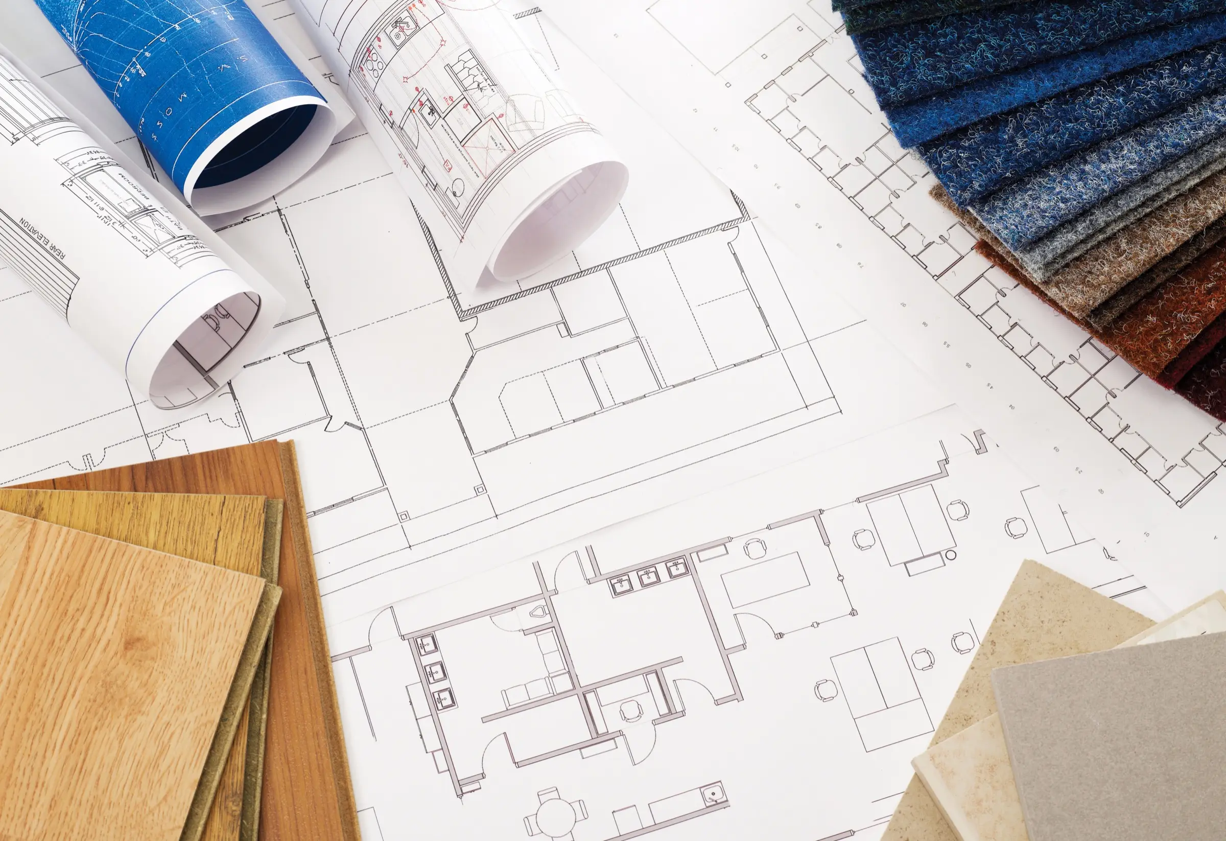 Architectural blueprints and material samples on a desk